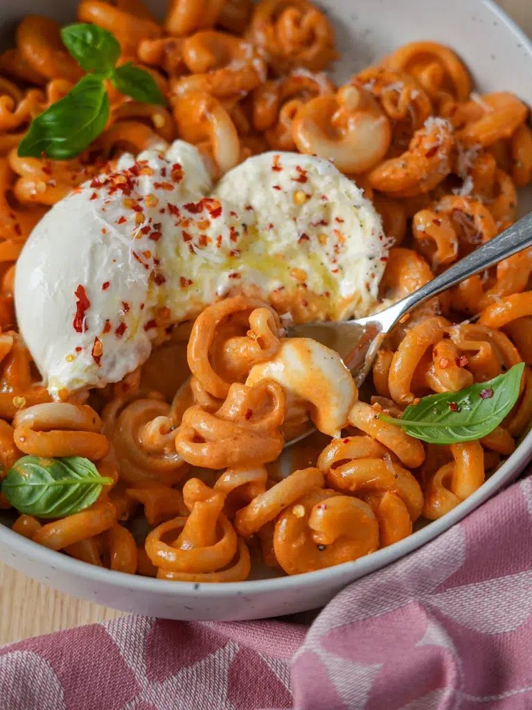 Close-up of a fork scooping creamy Not Spicy, Not Vodka Pasta from a plate, with pasta strands and sauce.