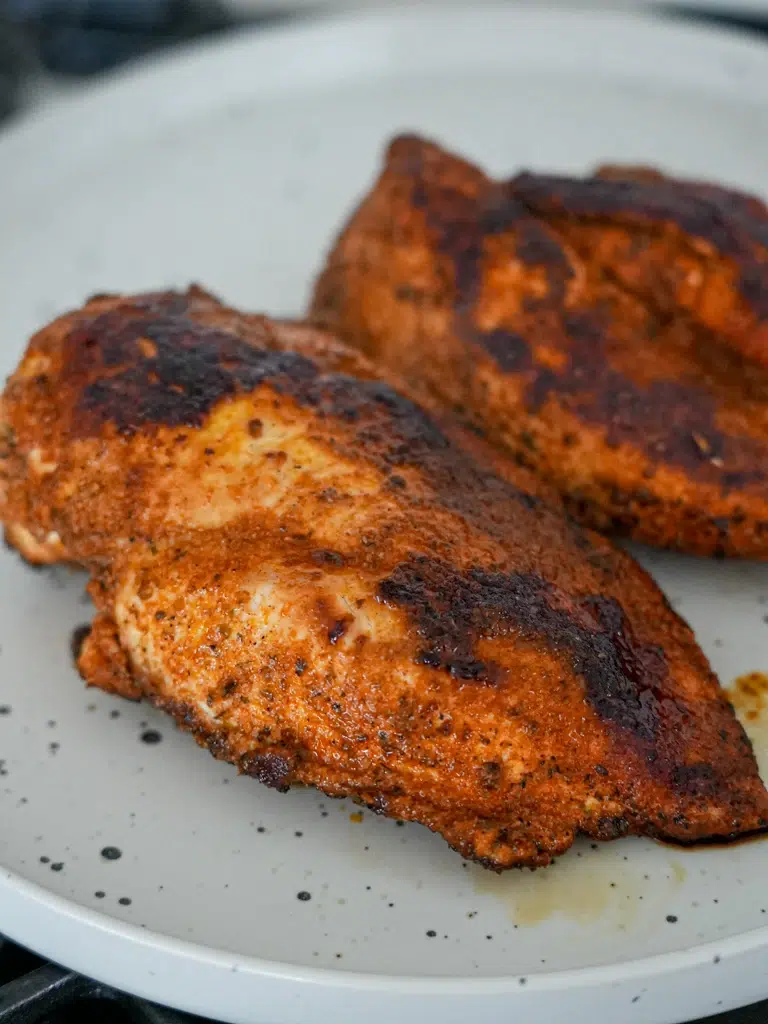 Close-up of seasoned cooked chicken for enchilada filling.