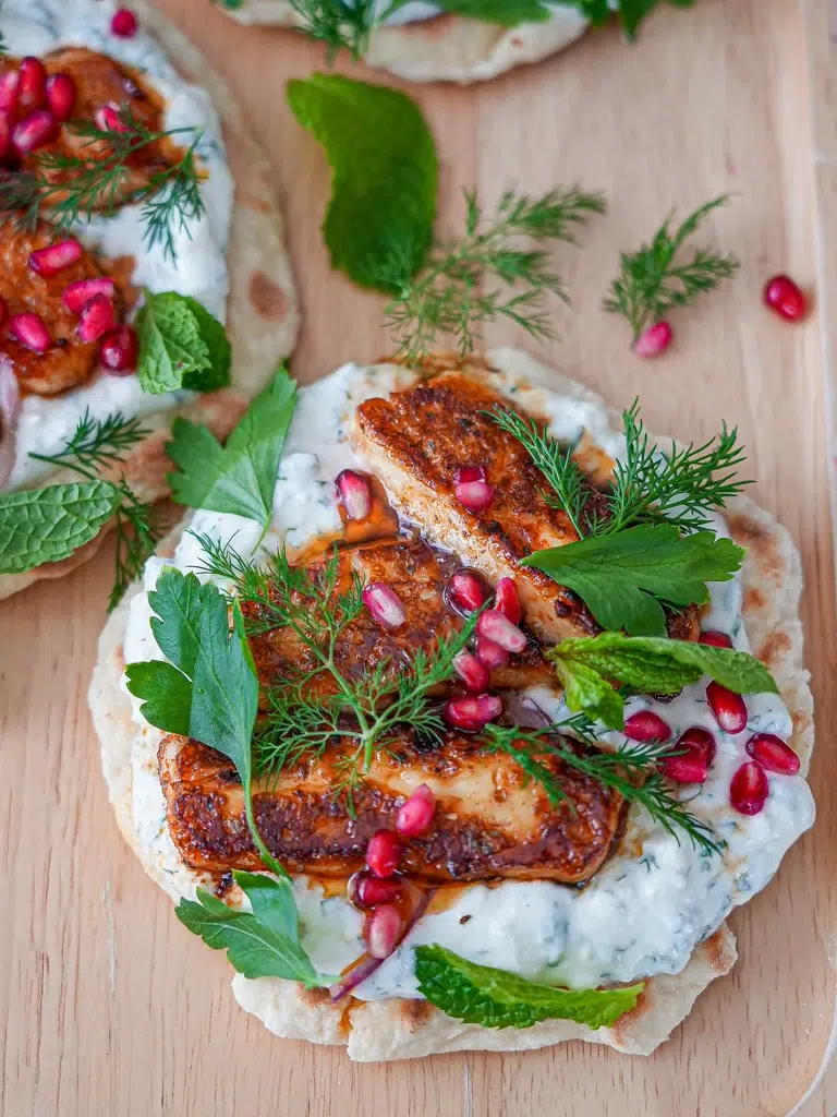 Beautifully seasoned halloumi cooked in hot honey sauce, stuffed into flatbreads with mint yogurt sauce, fresh herbs, and pomegranate.