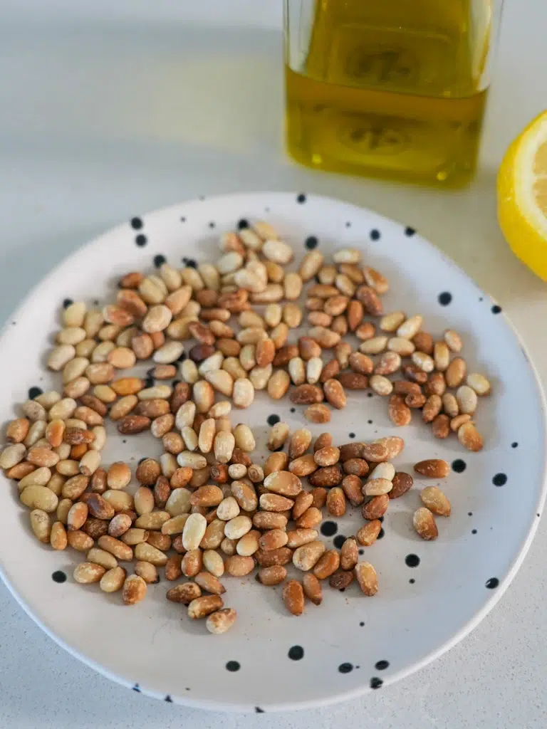 Pine nuts arranged on a white plate