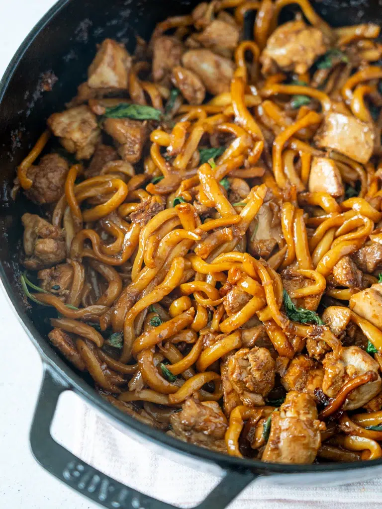 Close-up of a one-pan dish of Three-Cup Chicken Noodles, featuring tender chicken, noodles, and a savory three-cup sauce.