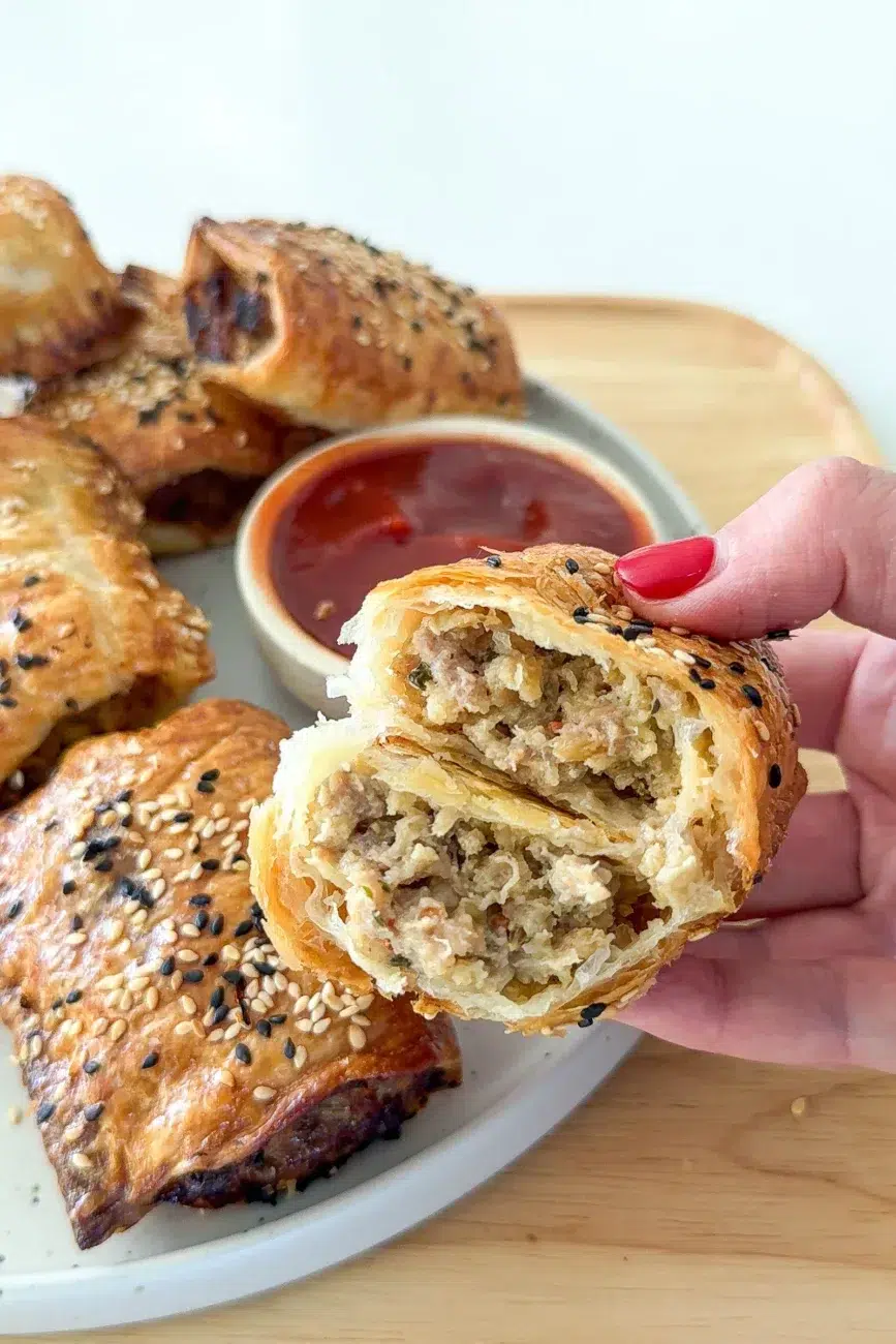 sausage roll halved to show juicy moist centre