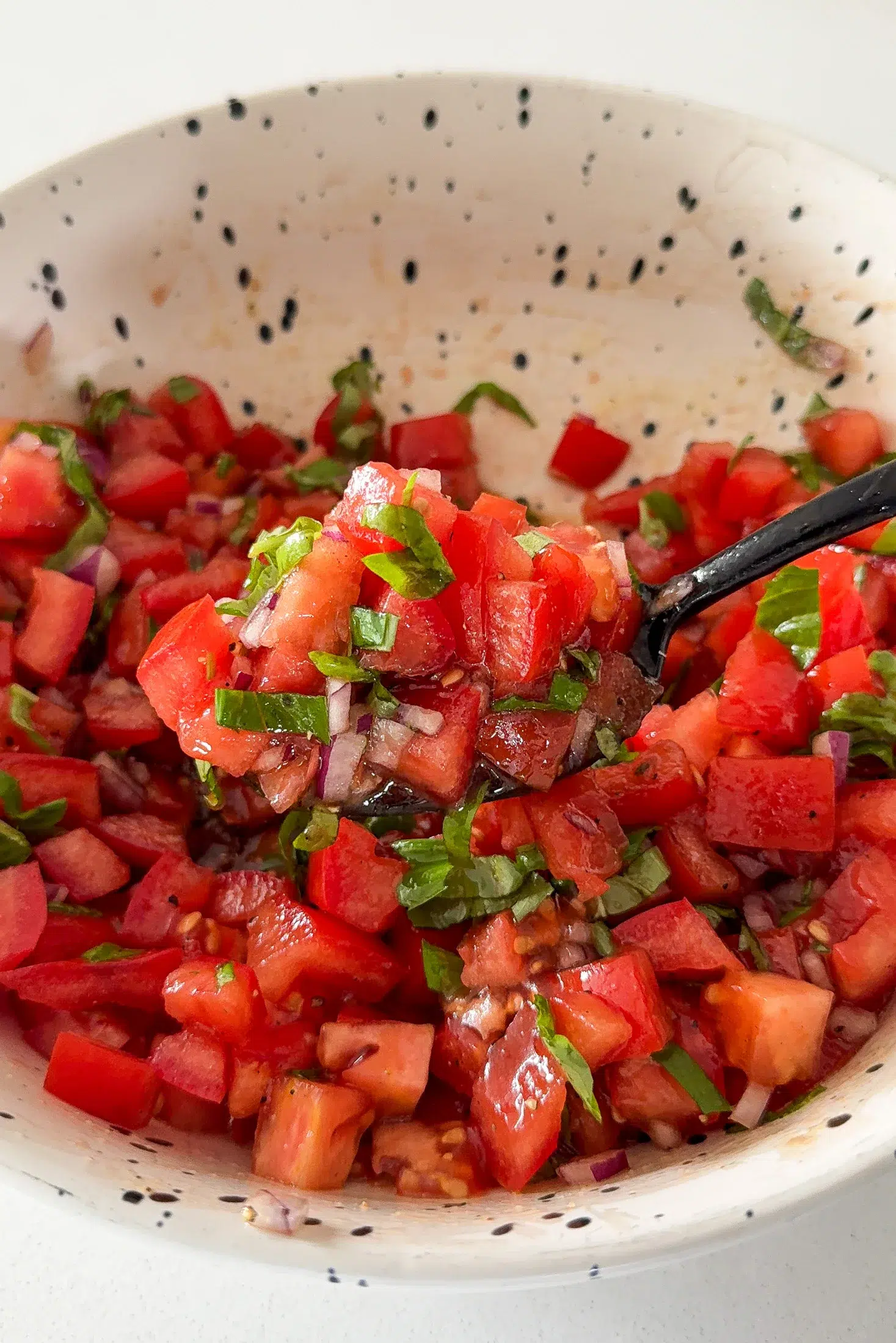 Tomatoes and basil mixed together for bruschetta salad